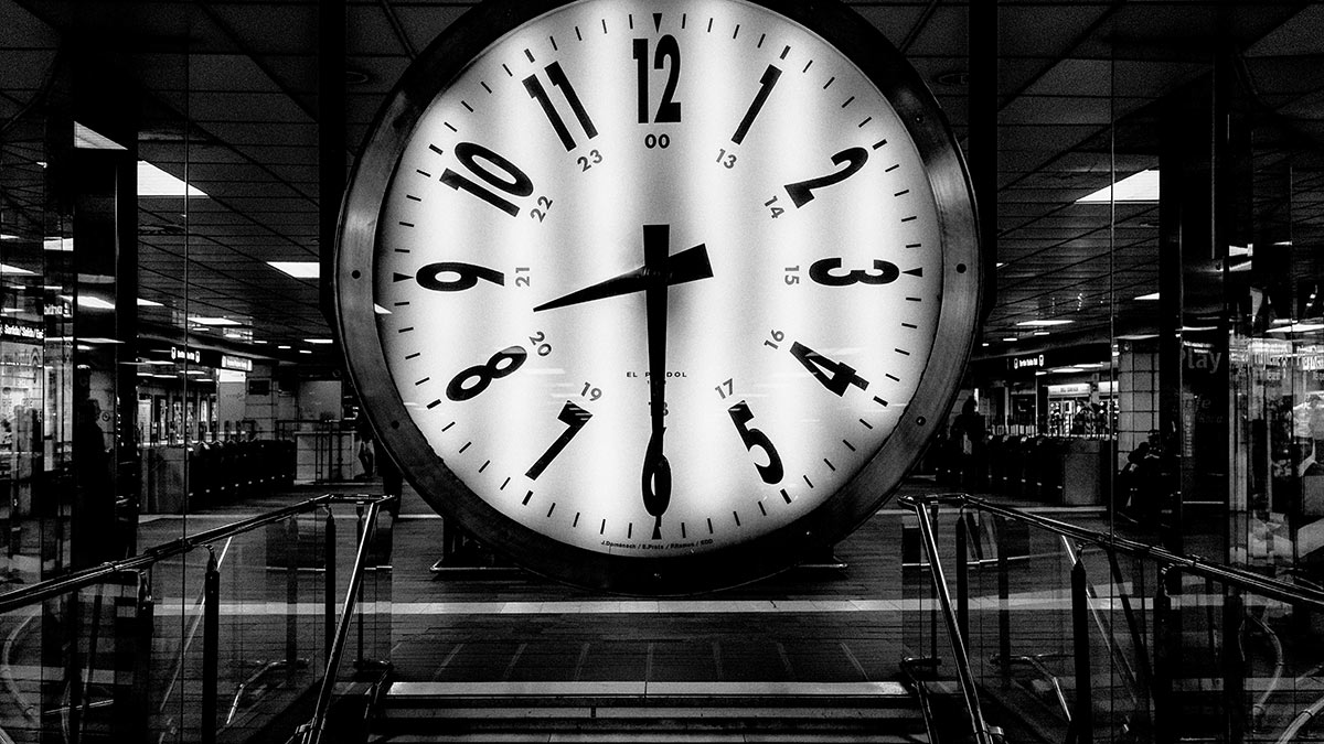 large clock at top of stairs